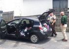 Sheriff Barry Babb (in the green shirt) and Traffic Investigator Jimmy Price examine a getaway vehicle abandoned in a North Glynn Street parking lot after two shoplifting suspects were caught and charged. Photo/Ben Nelms.